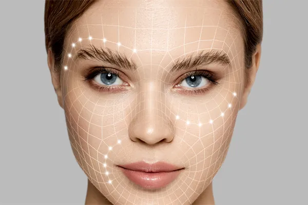 Aesthetic-Fillers-Doctor Close-up of a beautiful face against a gray background, with flowing gridlines illustrated along the cheeks, brow and lips, representing aesthetic filler services from Carolyn Zaumeyer, MSN, APRN in Fort Lauderdale.
