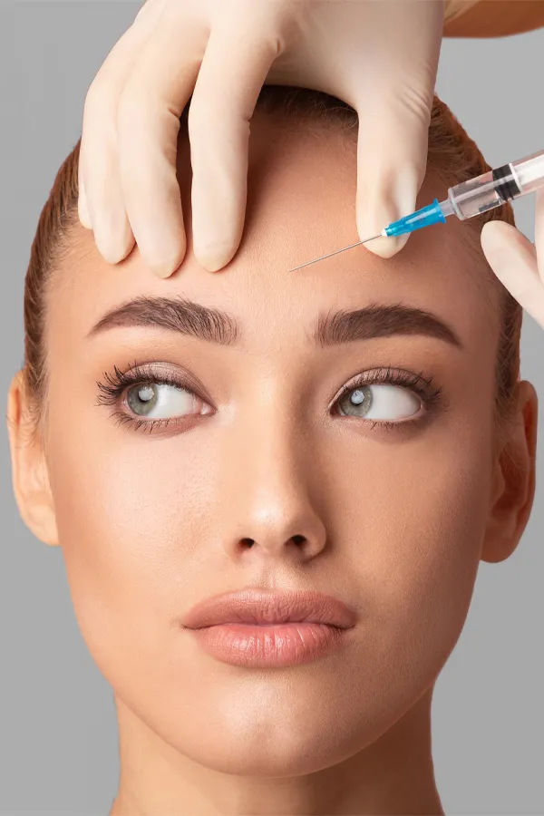 Close up of a woman with receiving a Botox injection in her brow from Carolyn Zaumeyer, MSN, APRN in Fort Lauderdale.